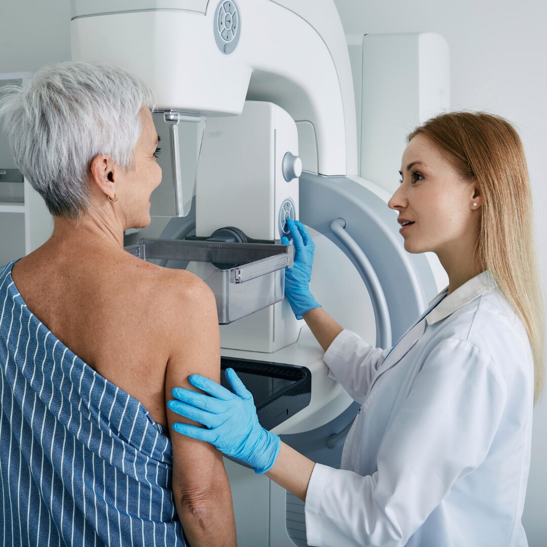 Woman in 40's and 50's getting a mammogram.